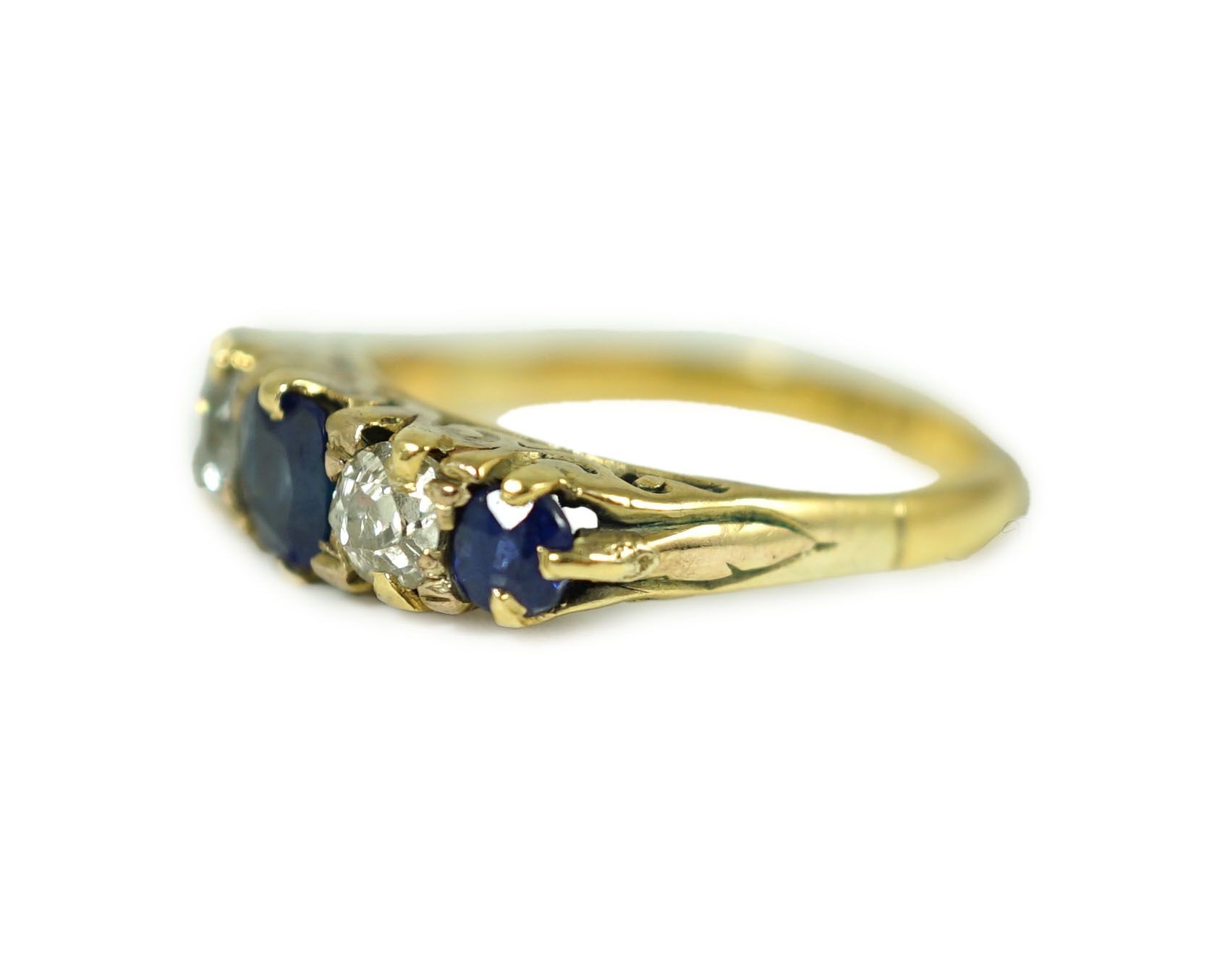 An 18ct gold, graduated three stone sapphire and two stone diamond set half hoop ring